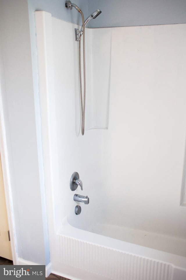 bathroom with shower / washtub combination