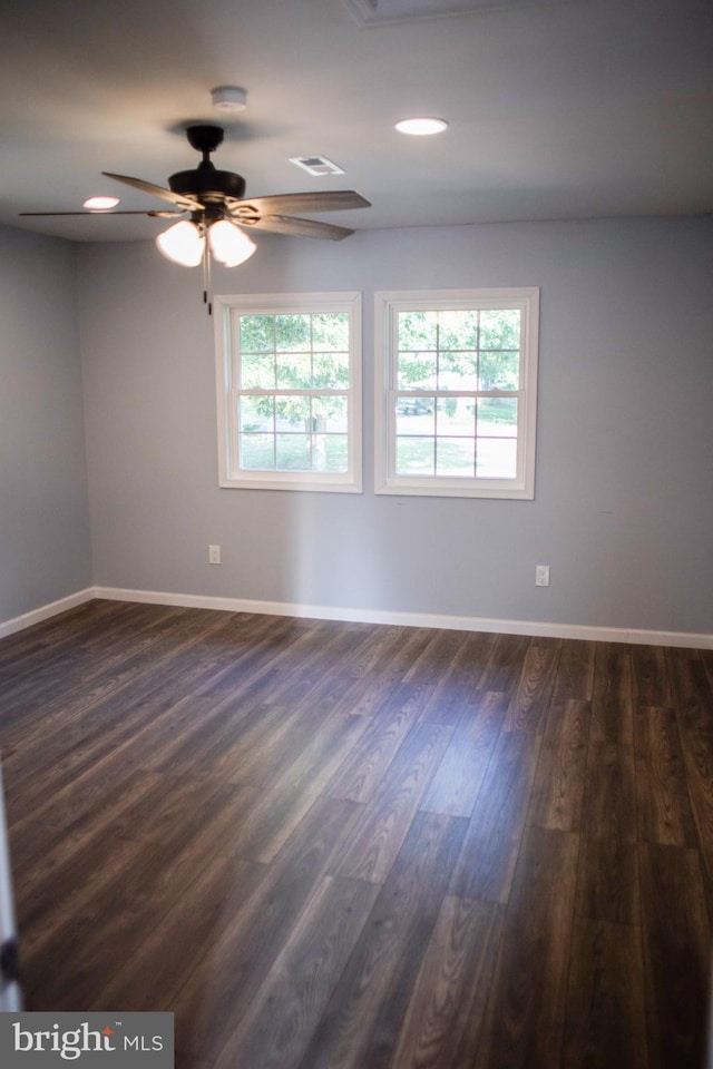 empty room with ceiling fan and dark hardwood / wood-style floors