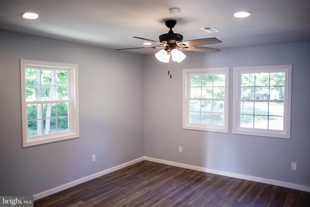 empty room with ceiling fan and dark hardwood / wood-style flooring