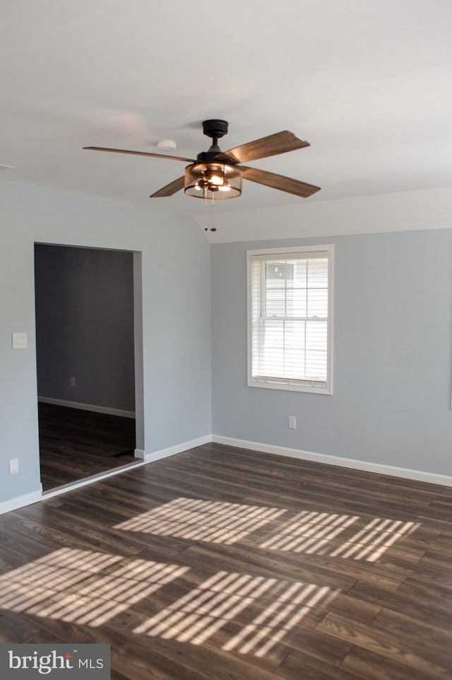 empty room featuring ceiling fan and dark hardwood / wood-style floors