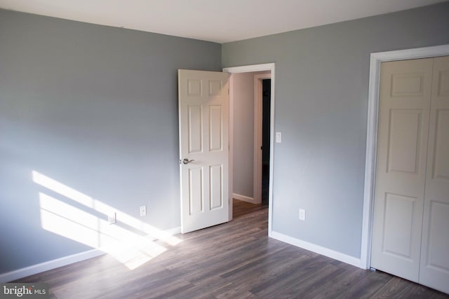 spare room with dark wood-type flooring