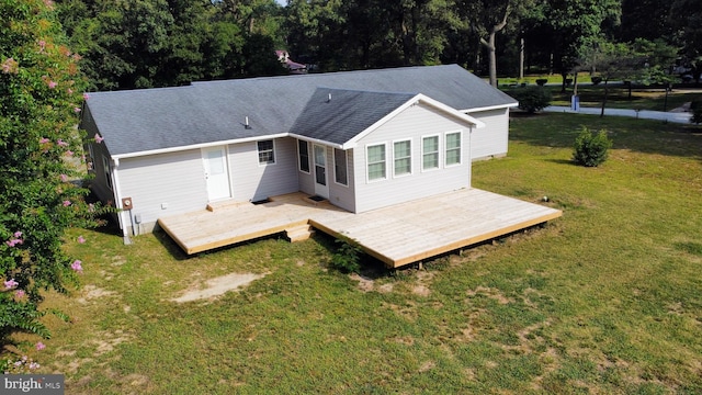 back of house with a yard and a deck