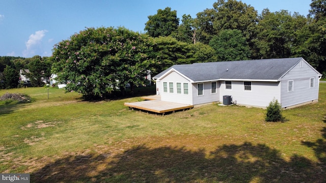 back of property featuring cooling unit, a lawn, and a deck