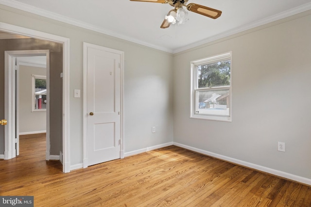 spare room featuring ceiling fan, light hardwood / wood-style floors, and ornamental molding