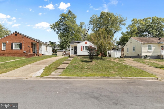 bungalow-style house with a front lawn, roof mounted solar panels, and driveway