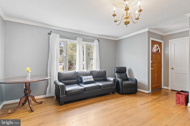 living room with crown molding, an inviting chandelier, and light wood-type flooring