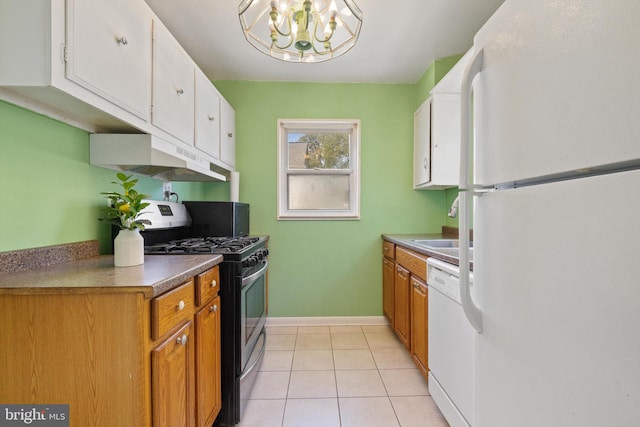 kitchen featuring a chandelier, light tile patterned floors, white appliances, and white cabinets