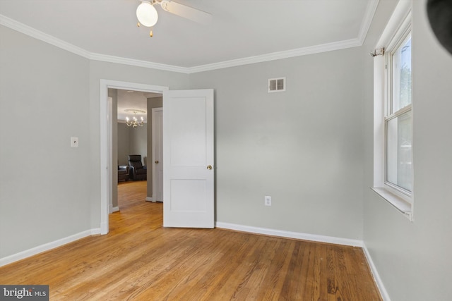 unfurnished room with ornamental molding, a healthy amount of sunlight, and light hardwood / wood-style floors