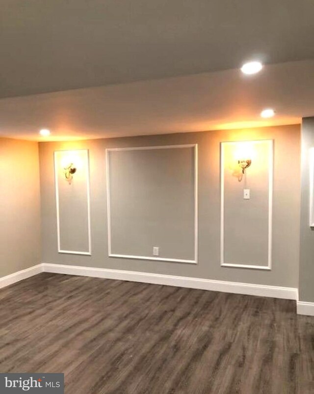 unfurnished room with dark wood-type flooring