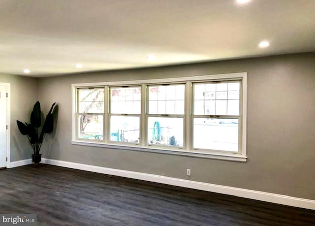 spare room with dark hardwood / wood-style flooring