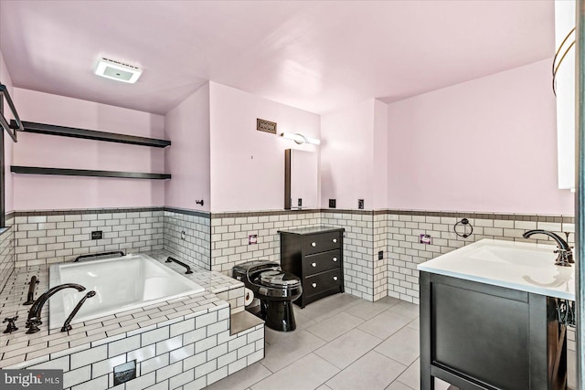 full bathroom featuring tile patterned flooring, a wainscoted wall, vanity, tile walls, and a bath