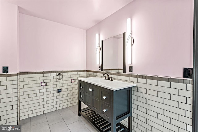 bathroom with wainscoting, vanity, tile walls, and tile patterned floors