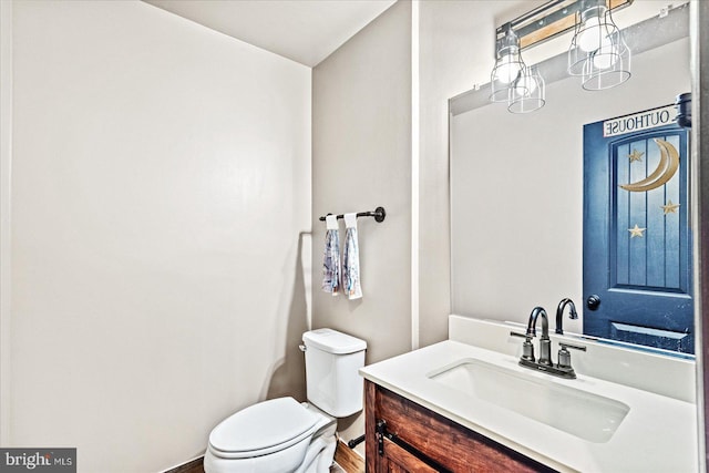 bathroom featuring toilet and vanity