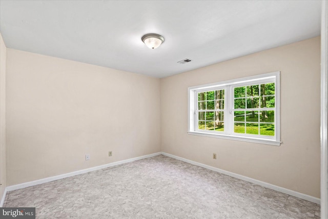 spare room with visible vents and baseboards