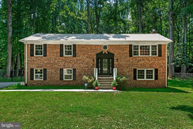 raised ranch with a front lawn