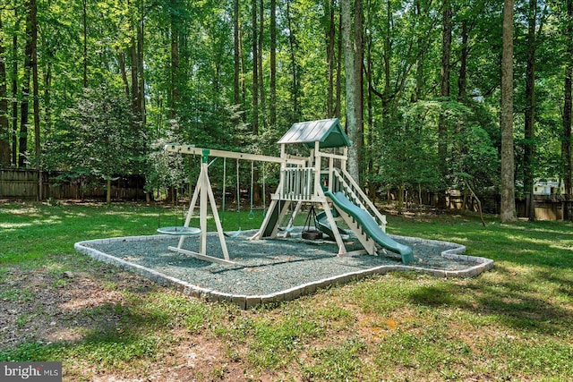 community play area featuring a fenced backyard and a yard