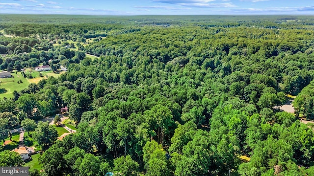 drone / aerial view featuring a forest view