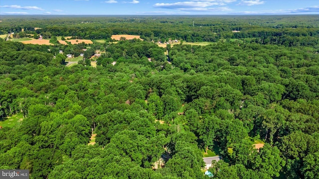 birds eye view of property with a wooded view