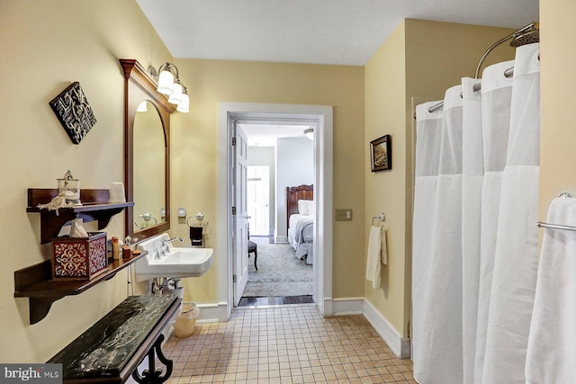 bathroom with sink and a shower with shower curtain