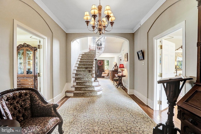 interior space with crown molding, a notable chandelier, and wood-type flooring