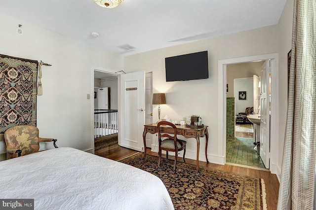 bedroom with dark hardwood / wood-style floors