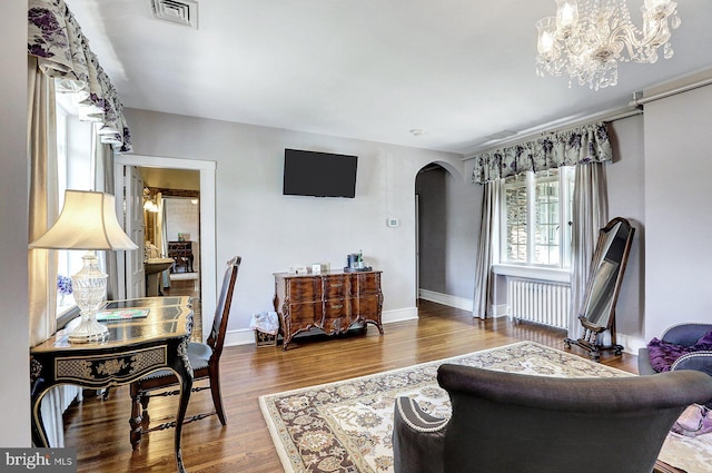 living room with radiator heating unit and wood-type flooring