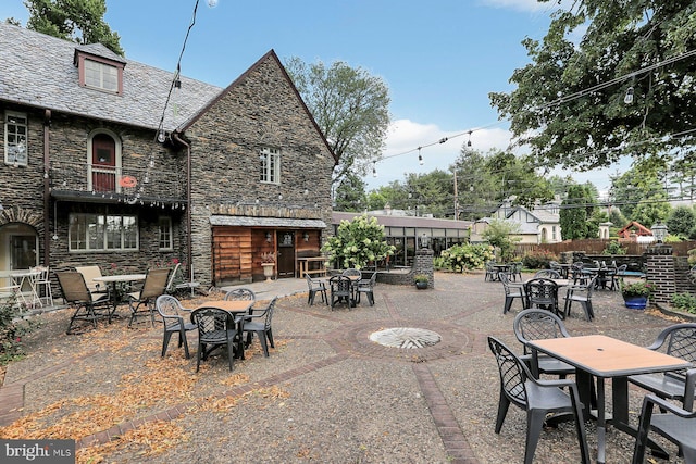 view of patio / terrace featuring outdoor dining area and fence