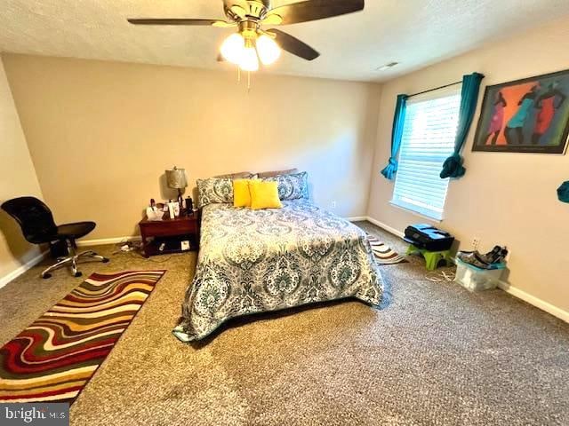 carpeted bedroom with ceiling fan