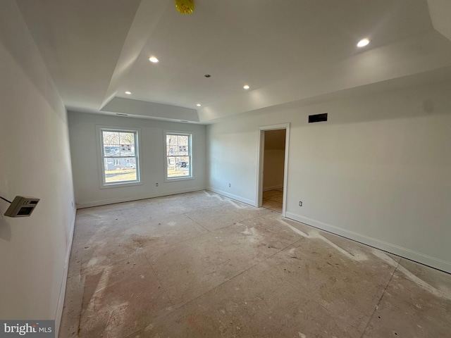 unfurnished room featuring a tray ceiling, baseboards, and recessed lighting