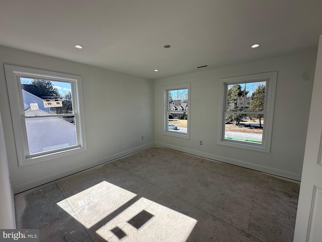 spare room featuring recessed lighting, visible vents, and baseboards