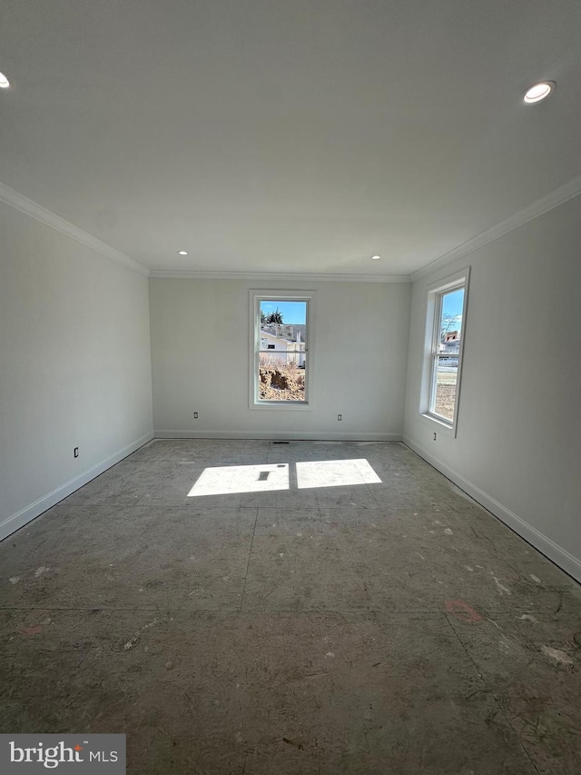 spare room with ornamental molding, recessed lighting, and baseboards