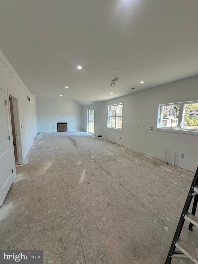 unfurnished living room featuring ornamental molding and recessed lighting