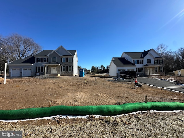 view of front of property featuring an attached garage and stone siding