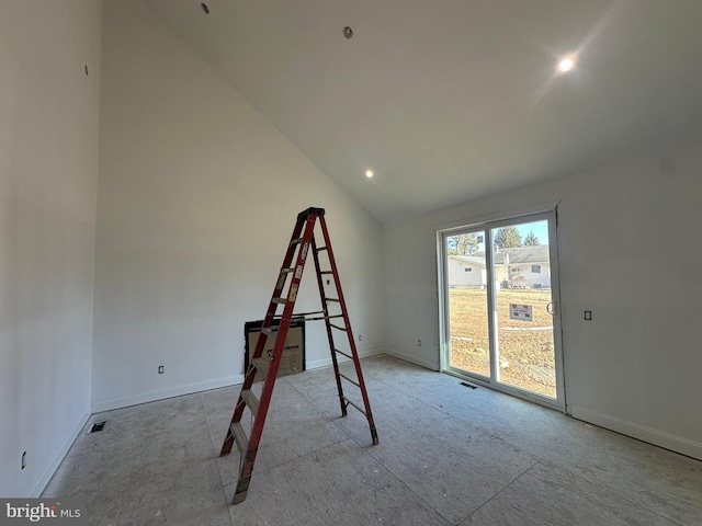 unfurnished room with lofted ceiling and baseboards