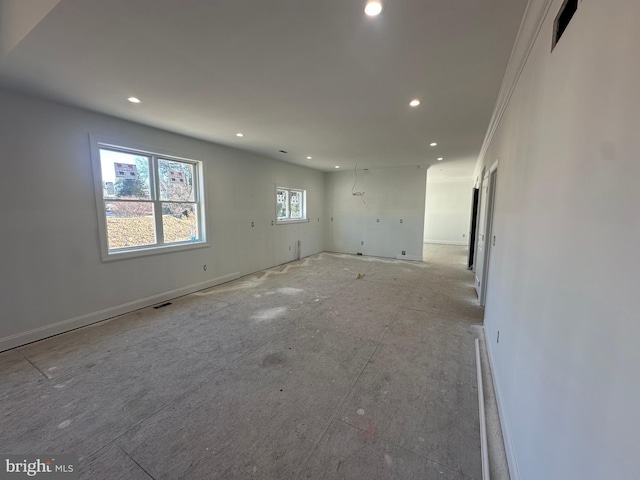 spare room with recessed lighting and baseboards