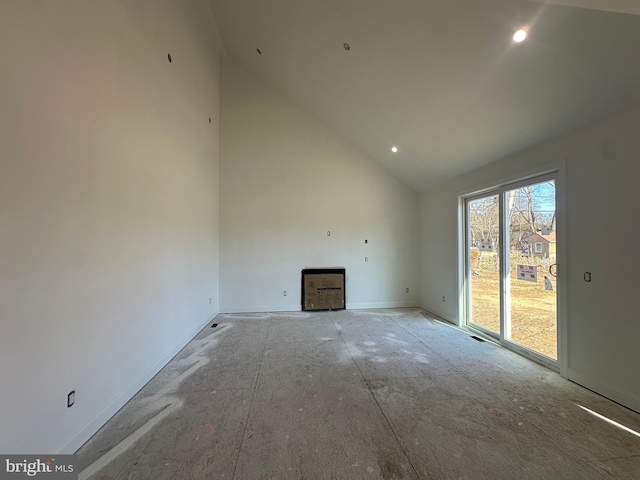 unfurnished living room featuring high vaulted ceiling