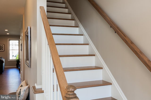 stairs featuring wood-type flooring