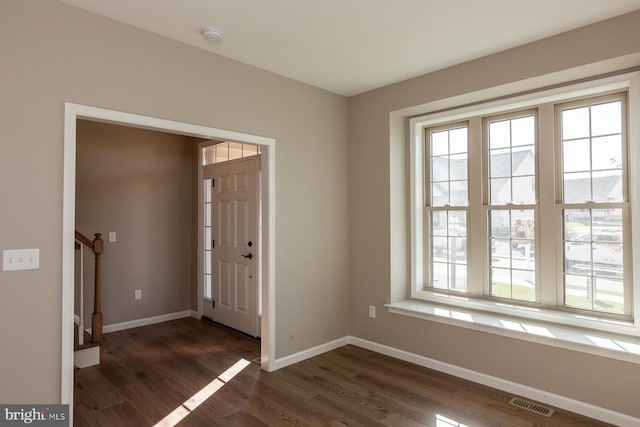 entrance foyer with dark hardwood / wood-style floors