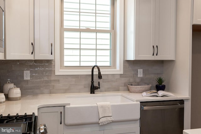 details featuring dishwasher, sink, range, white cabinets, and tasteful backsplash