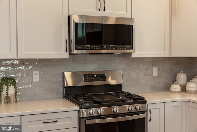 kitchen featuring tasteful backsplash, appliances with stainless steel finishes, and white cabinets