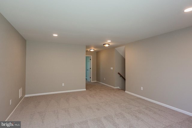 unfurnished room with light colored carpet