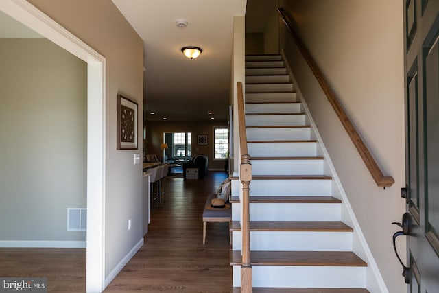 stairs with hardwood / wood-style flooring