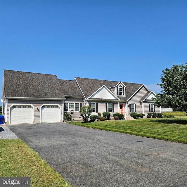 view of front of property featuring a garage and a front lawn