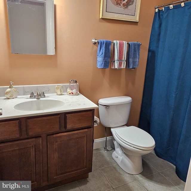 bathroom with tile patterned floors, vanity, and toilet