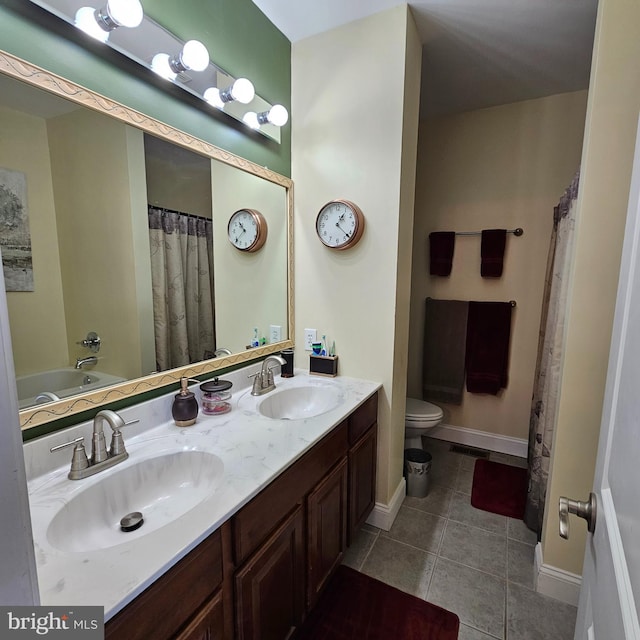 bathroom featuring tile patterned flooring, vanity, and toilet