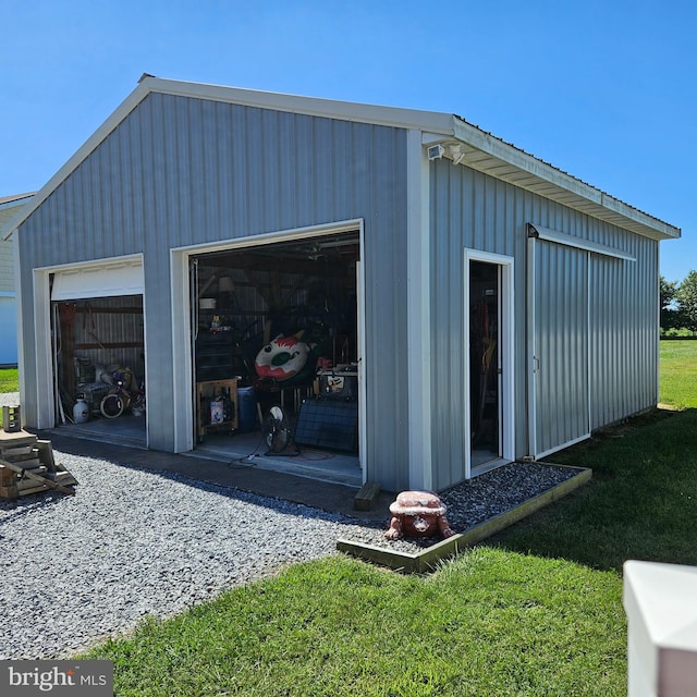 view of outbuilding with a garage and a yard