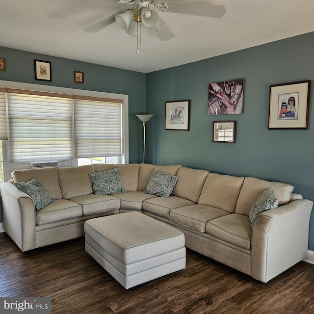 living room with dark hardwood / wood-style flooring and ceiling fan