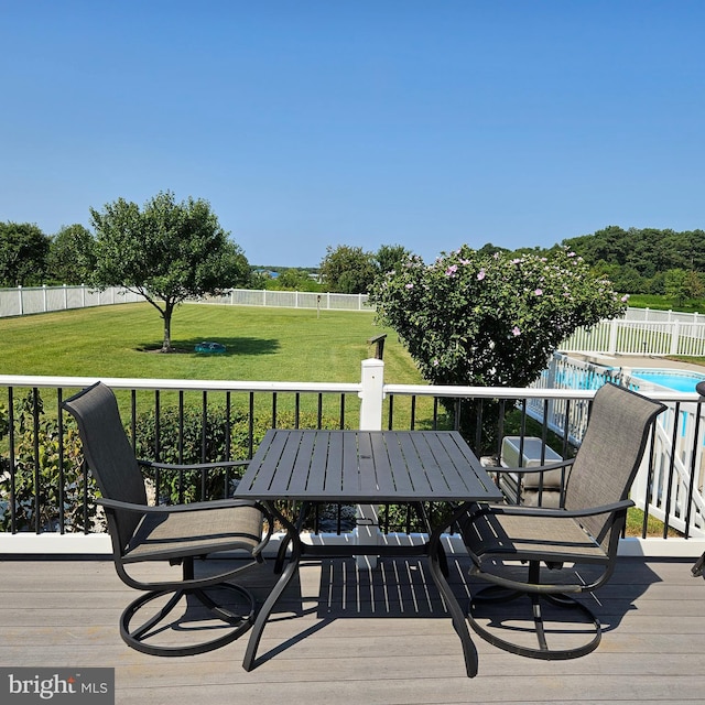 wooden terrace featuring a covered pool and a yard