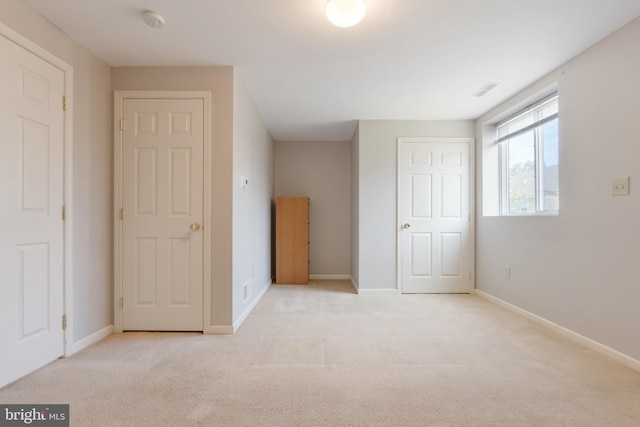 unfurnished bedroom featuring light colored carpet