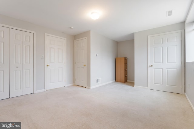 unfurnished bedroom with light colored carpet